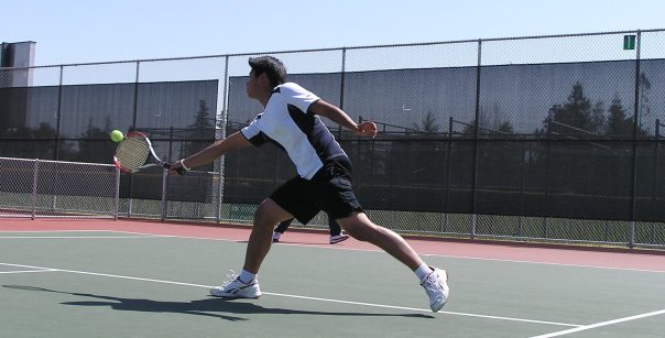 boy playing tennis
